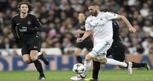 Real Madrid's French forward Karim Benzema (R) vies with Paris Saint-Germain's French midfielder Adrien Rabiot (L) during the UEFA Champions League round of sixteen first leg football match Real Madrid CF against Paris Saint-Germain (PSG) at the Santiago Bernabeu stadium in Madrid on February 14, 2018. / AFP PHOTO / GABRIEL BOUYS (Photo credit should read GABRIEL BOUYS/AFP/Getty Images)