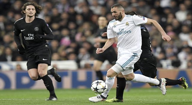 Real Madrid's French forward Karim Benzema (R) vies with Paris Saint-Germain's French midfielder Adrien Rabiot (L) during the UEFA Champions League round of sixteen first leg football match Real Madrid CF against Paris Saint-Germain (PSG) at the Santiago Bernabeu stadium in Madrid on February 14, 2018. / AFP PHOTO / GABRIEL BOUYS (Photo credit should read GABRIEL BOUYS/AFP/Getty Images)